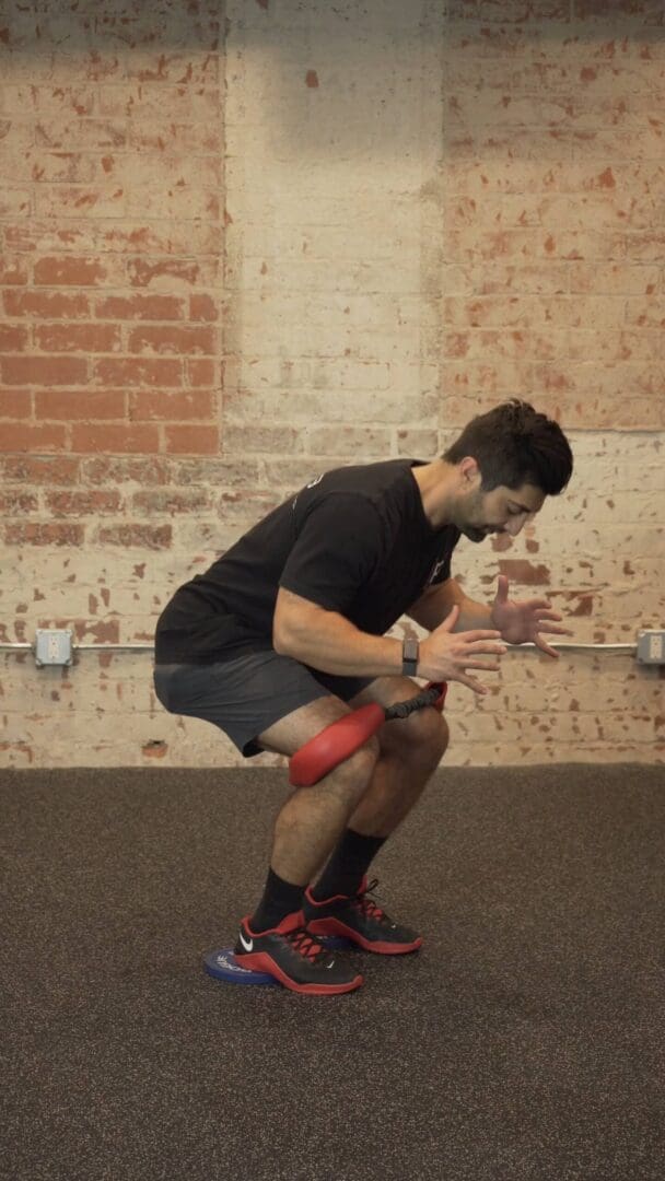 Squat Pulse Heels Elevated Band Around Knees P rehab